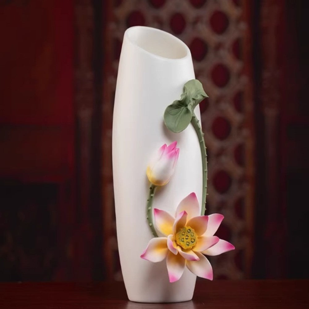 white ceramic floral relief vase with lotus design in warm ambient lighting