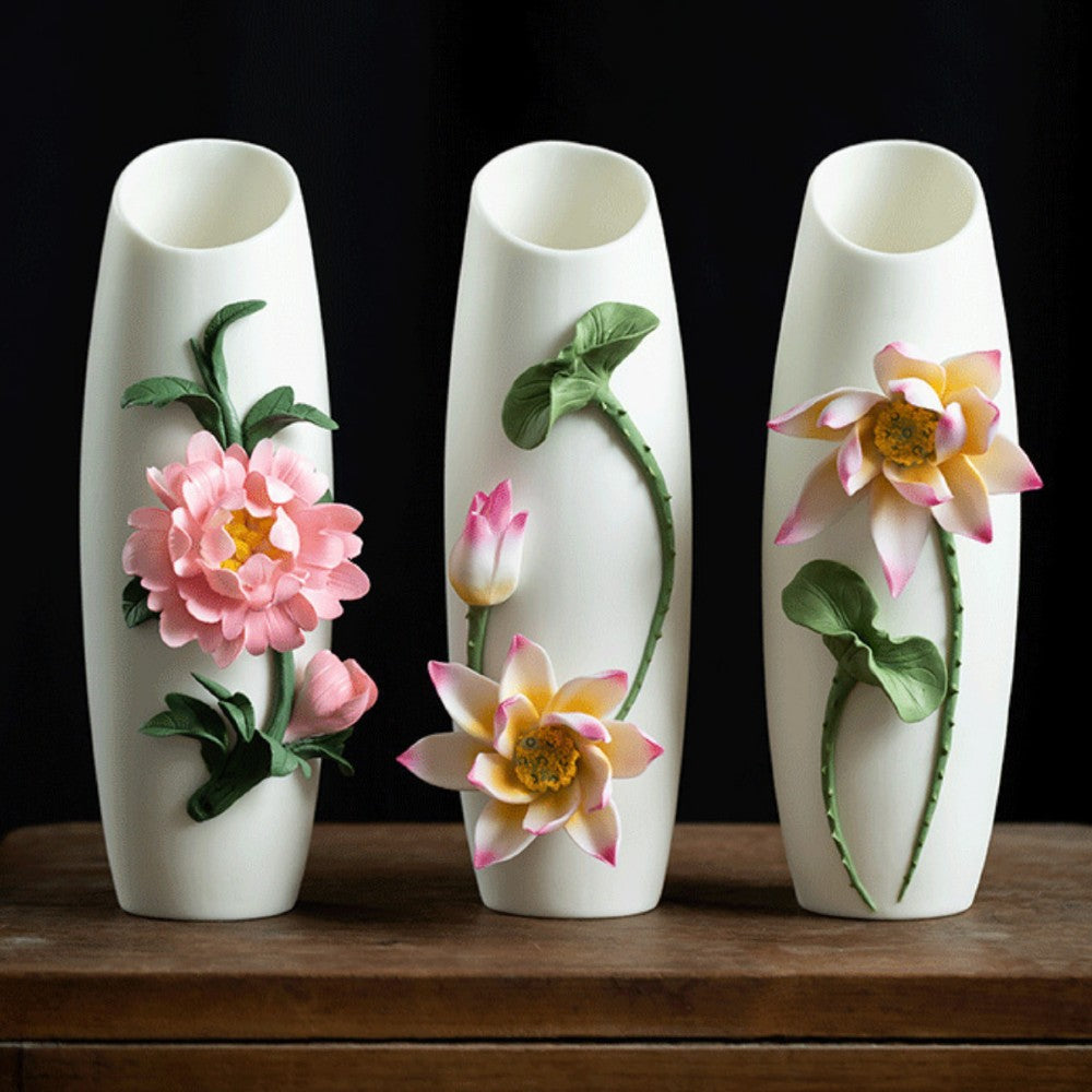 handcrafted floral relief ceramic vases set with peony and lotus designs on wooden table