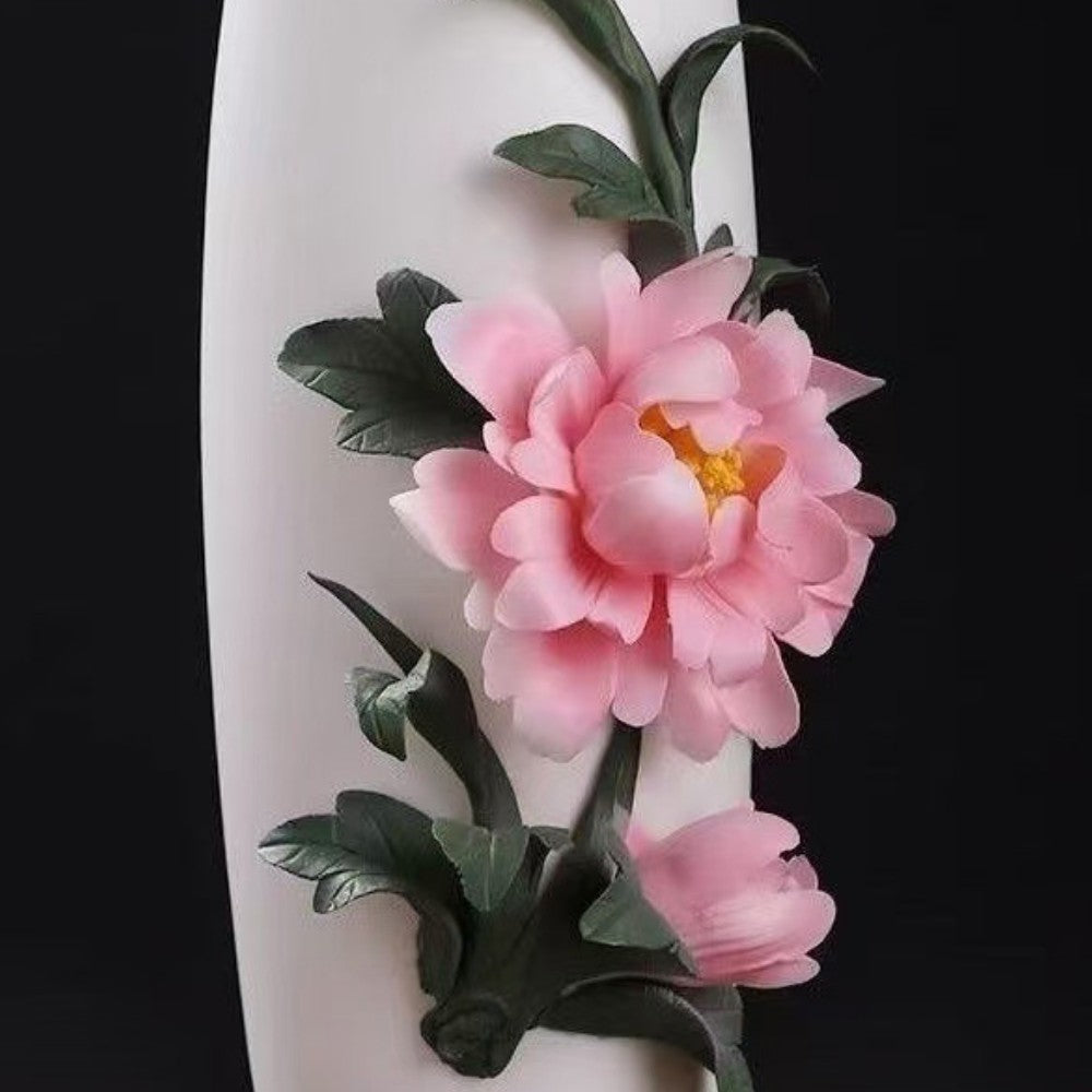 close up of peony floral relief ceramic vase highlighting sculpted petals and leaves