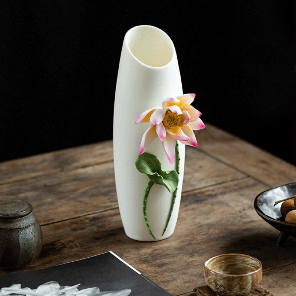 white ceramic vase with sculpted lotus flower relief in modern minimal setting