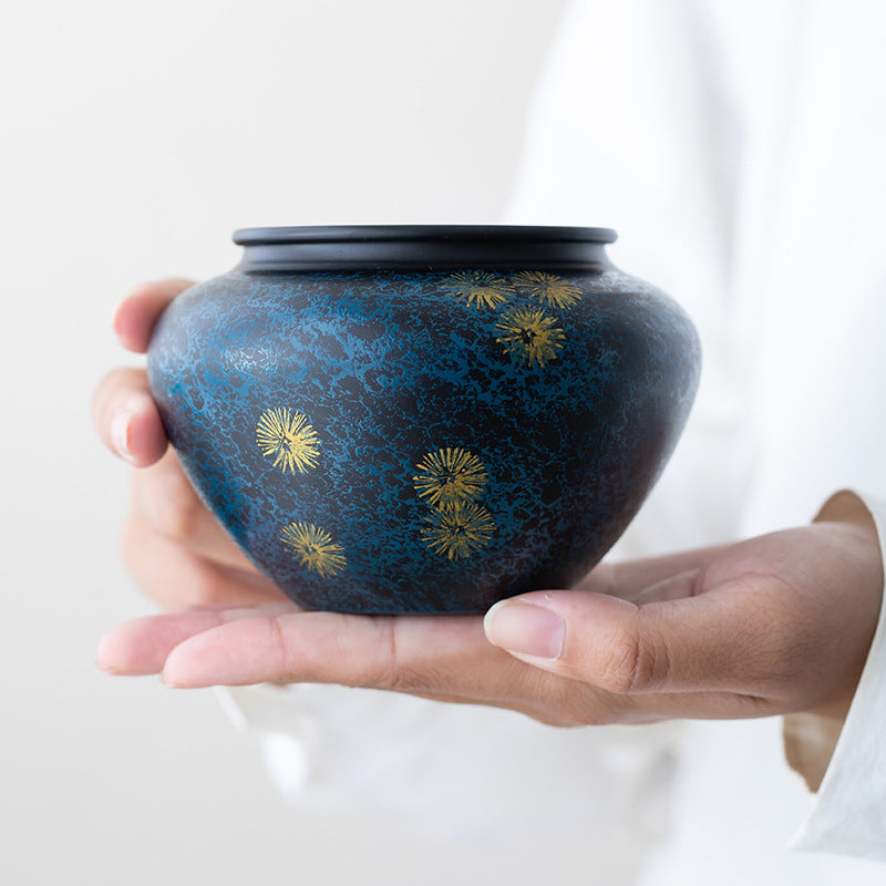 Midnight Blue handcrafted iron tea ritual bowl with gold starburst detailing held in hands