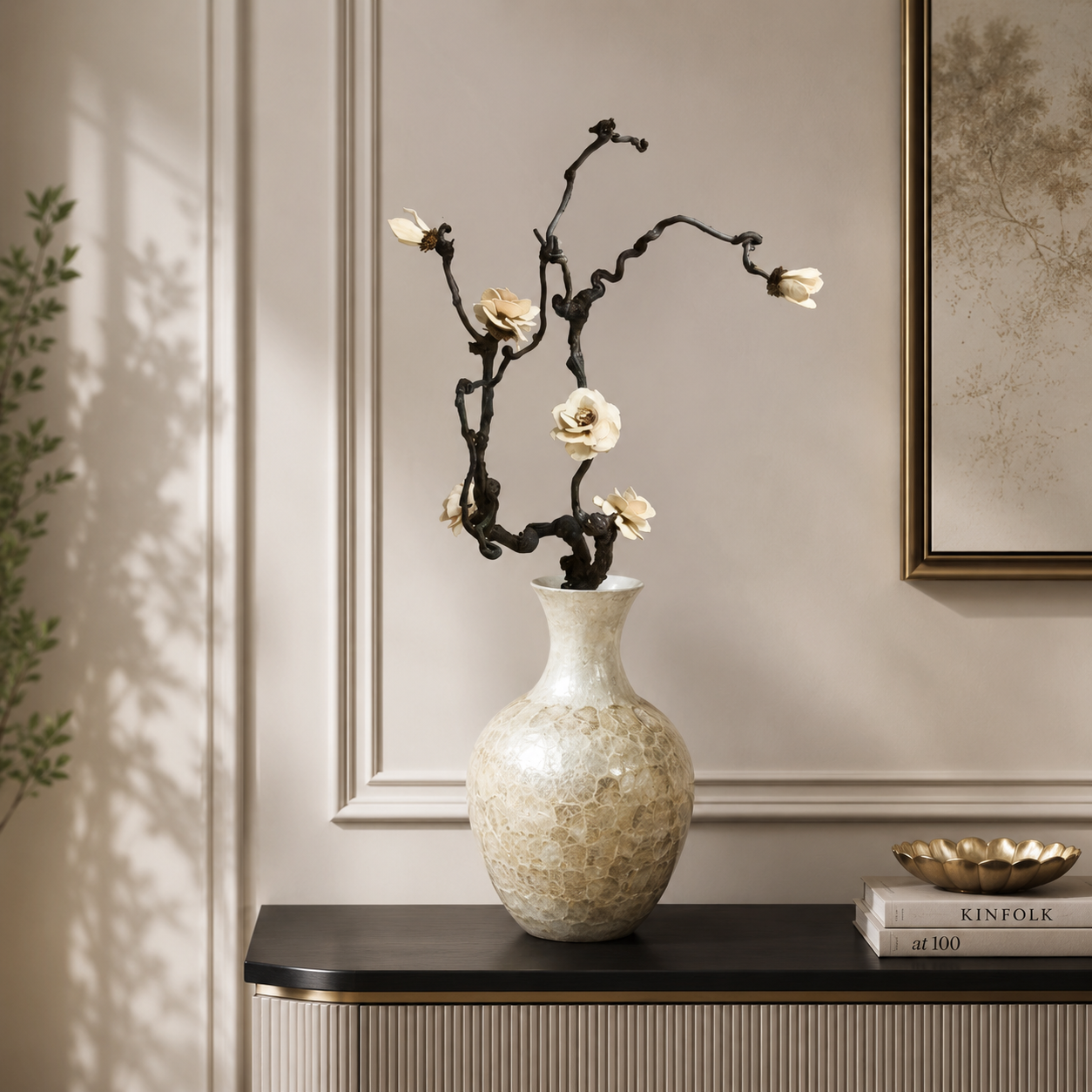 Handcrafted shell ceramic vase styled on console table with dried floral arrangement