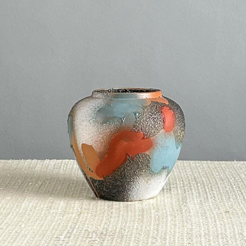 Small handmade abstract glaze ceramic vase with rounded shape and textured finish