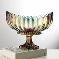 Iridescent footed glass centerpiece bowl with a scalloped rim displayed on stacked books