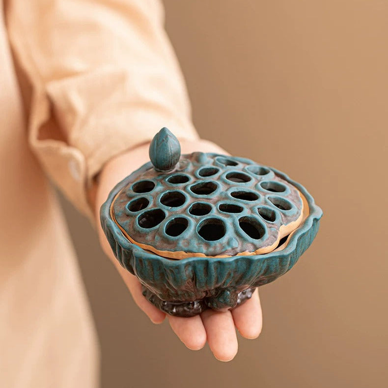 Patina Teal lotus pod ceramic incense burner held in hand