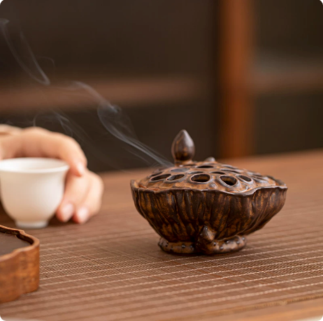 Rustic Brown lotus pod ceramic incense burner releasing incense smoke