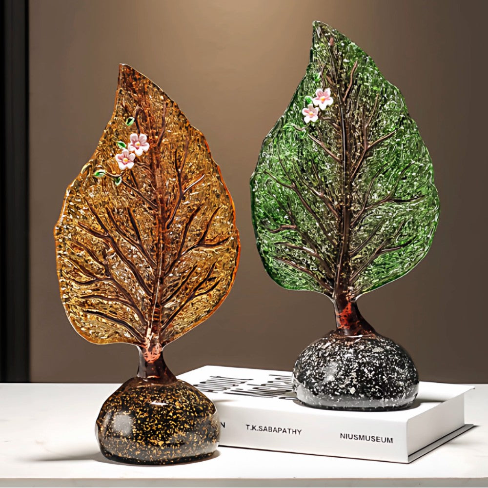 Amber glass leaf sculptures in gold and green finish displayed together