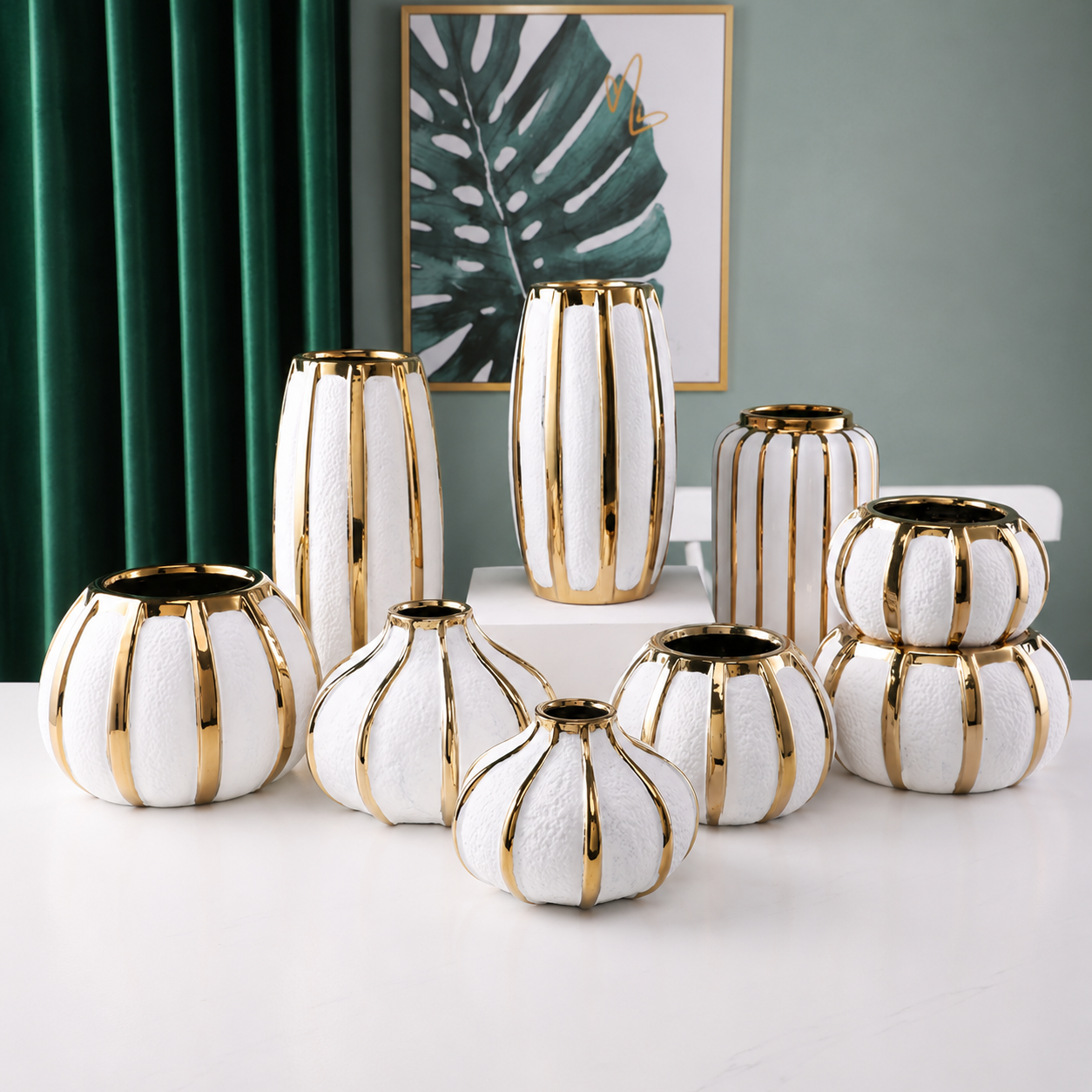 Assorted luxury white ceramic vases with gold accents displayed together in multiple shapes