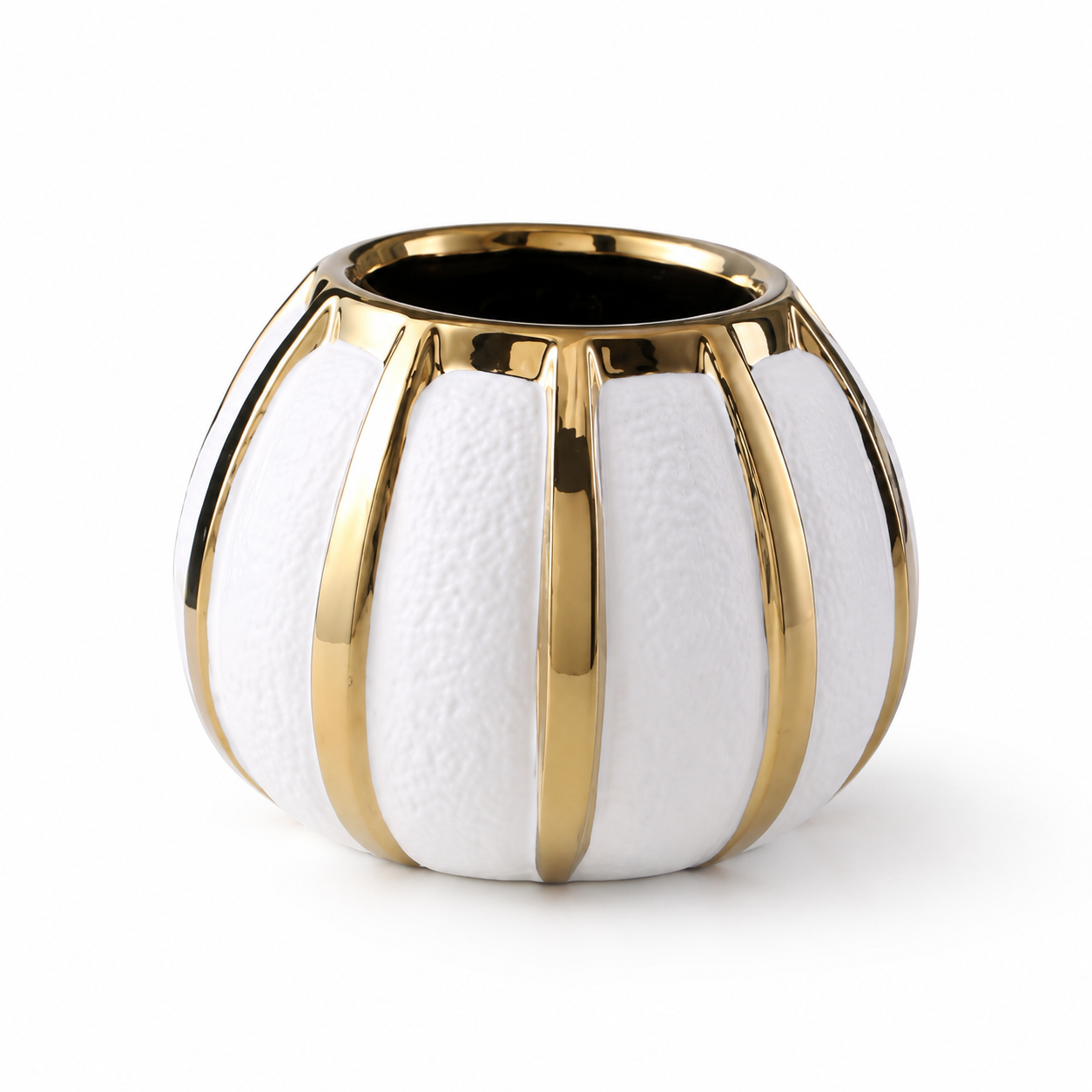 Round white ceramic vase with gold accents and textured panels on white background