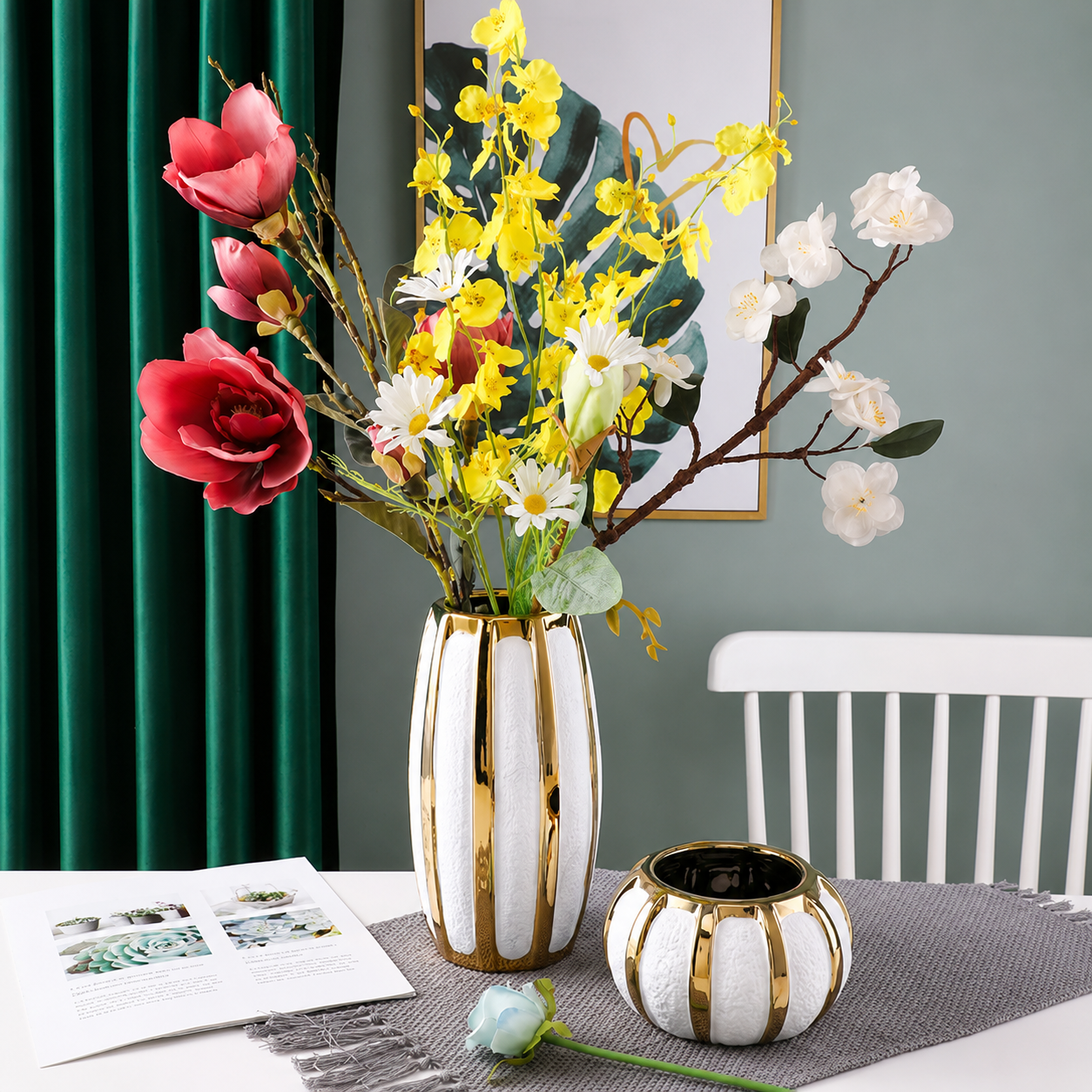 Luxury white ceramic vase with gold accents styled with colorful flowers beside a matching round vase