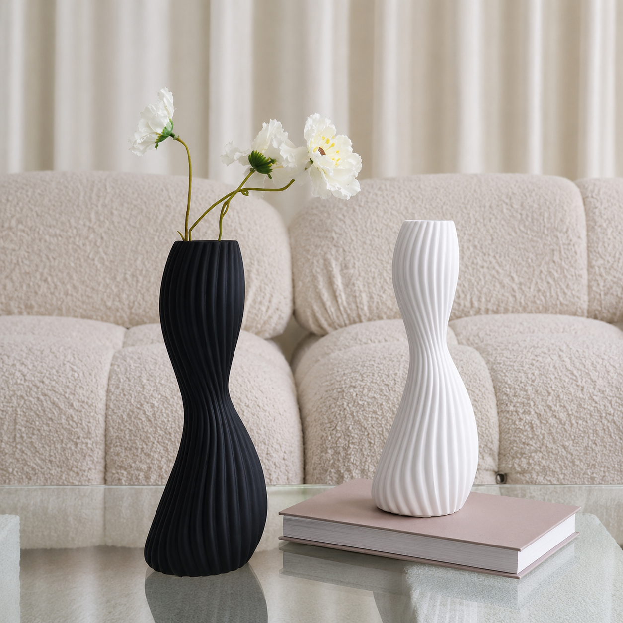 Black and white ribbed ceramic twist vases styled together on modern coffee table