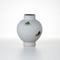Medium white ceramic round mountain vase on a clean white background
