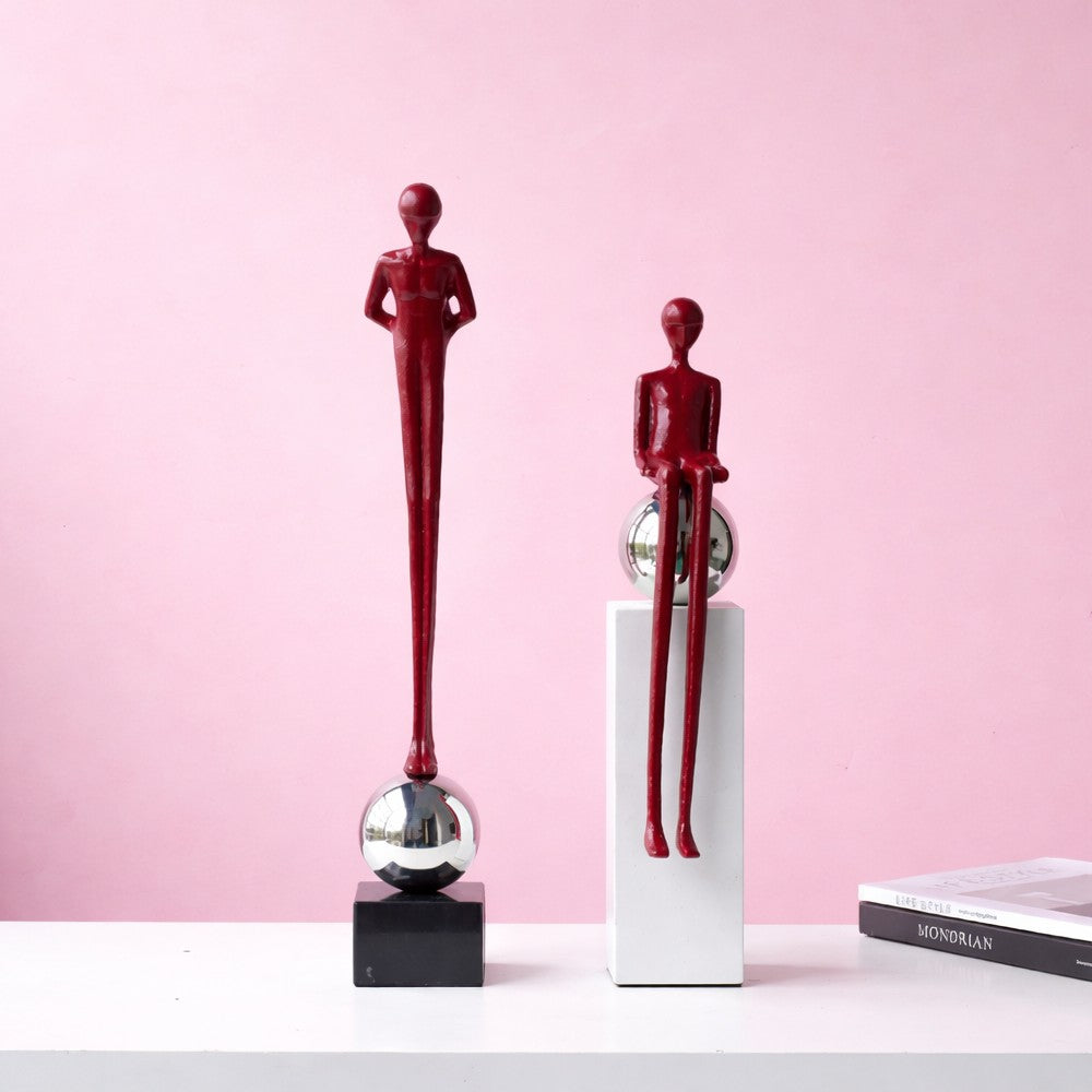 Burgundy standing and sitting alloy figure sculptures on chrome sphere bases
