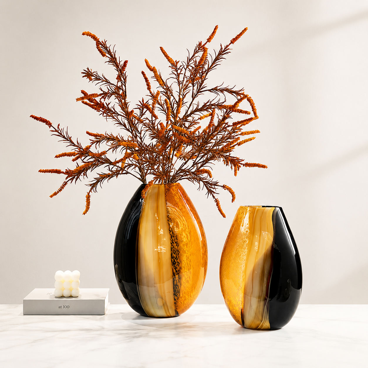 Modern amber and black hand blown glass vases styled with dried orange branches