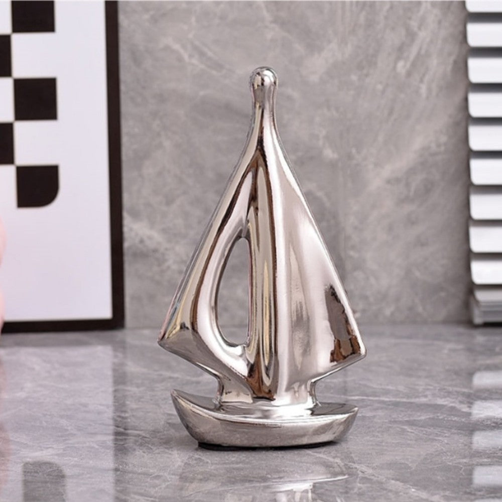 Small silver ceramic sailboat sculpture for tabletop and shelf styling