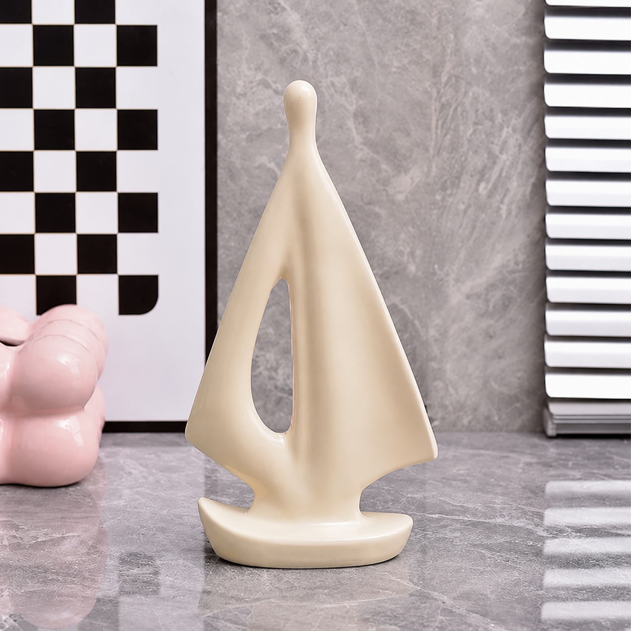 Large cream ceramic sailboat sculpture with smooth modern sail design