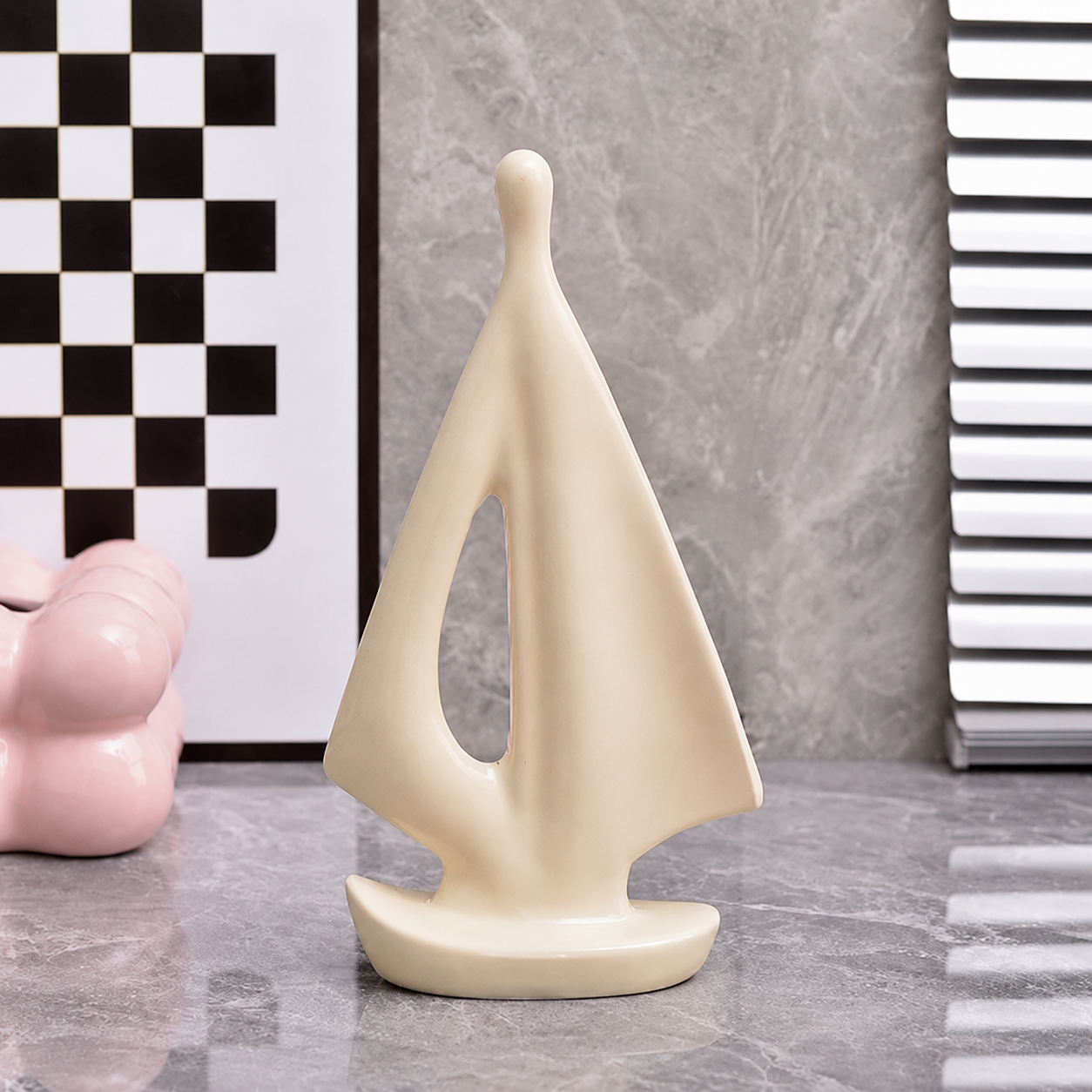 Small cream ceramic sailboat sculpture for modern coastal shelf decor