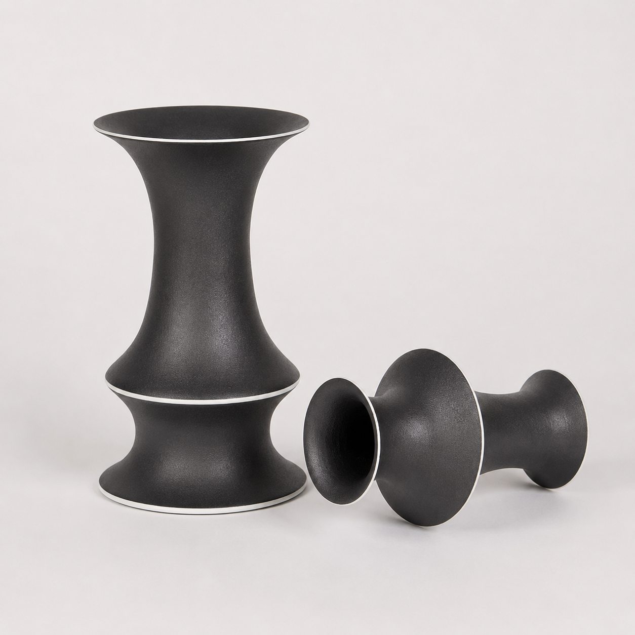 Black ceramic vase styling image showing upright and side view with contrast rim
