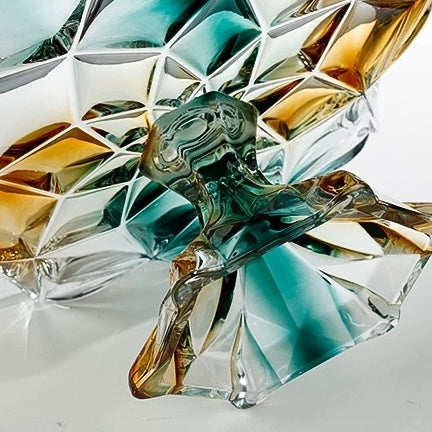 Detailed underside view of faceted glass centerpiece bowl and sculptural pedestal