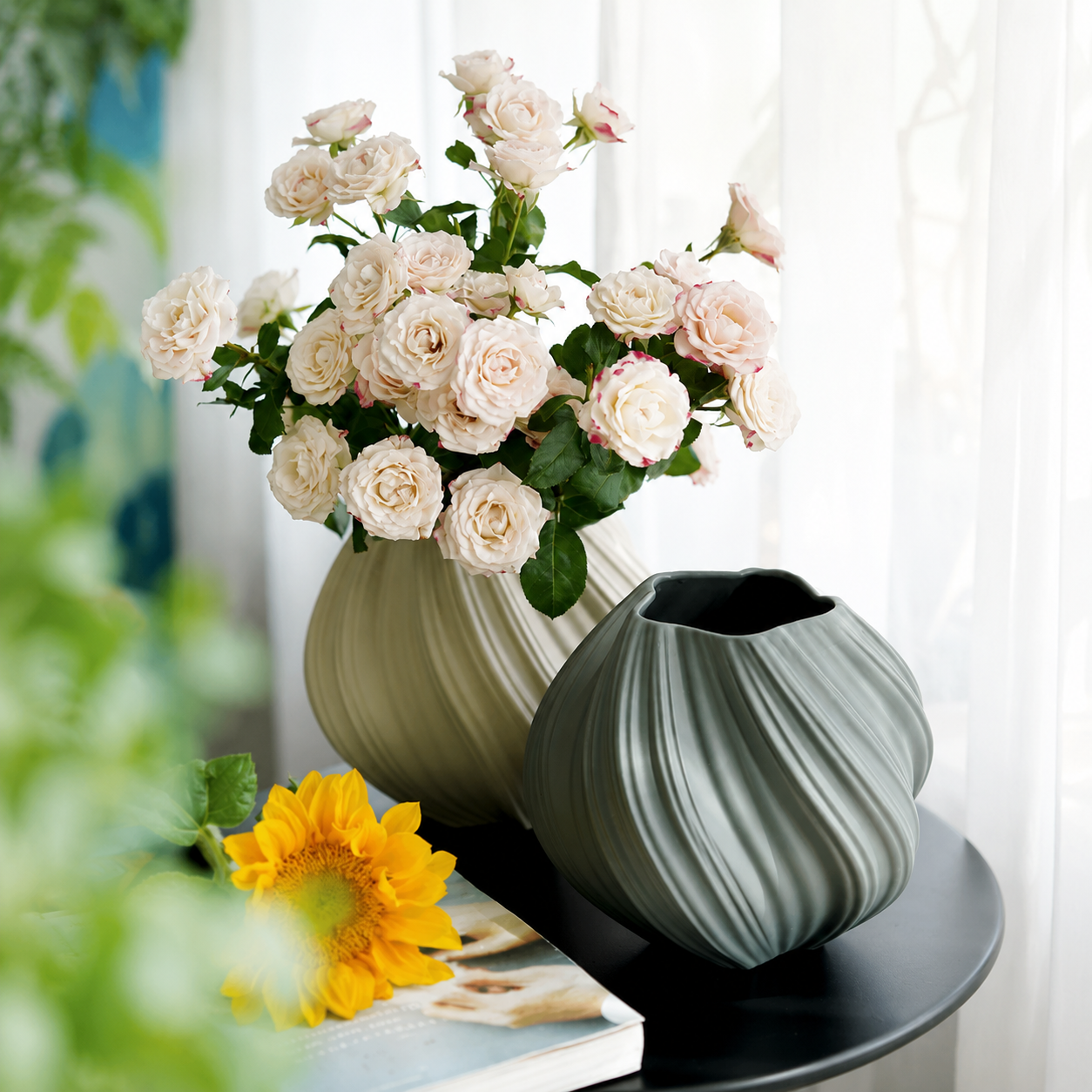 Warm beige and slate gray ribbed swirl ceramic vases styled with roses and sunflower by window