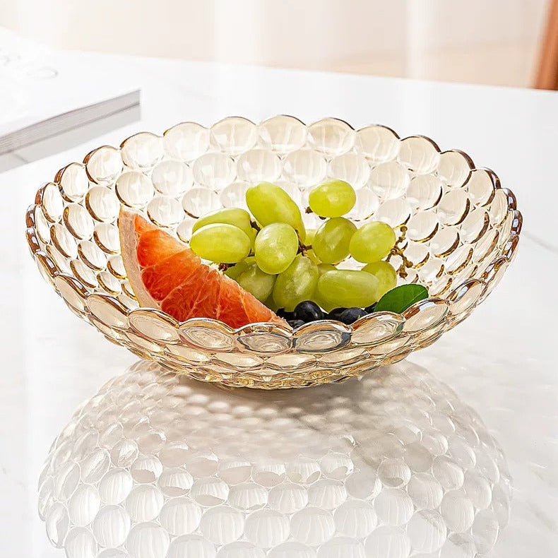 Amber bubble glass centerpiece bowl filled with colorful fruit on white tabletop