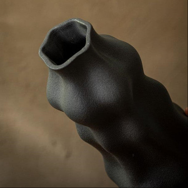 Close up of the textured matte finish and opening of the black ceramic vase