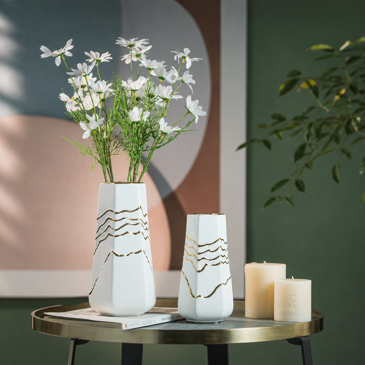 White ceramic mountain line vases with white flowers on a modern side table