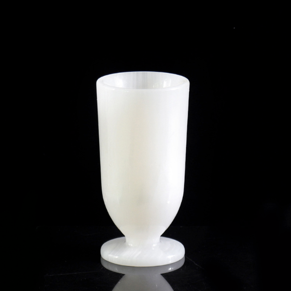 White marble pedestal vase product photo with smooth polished finish on dark background