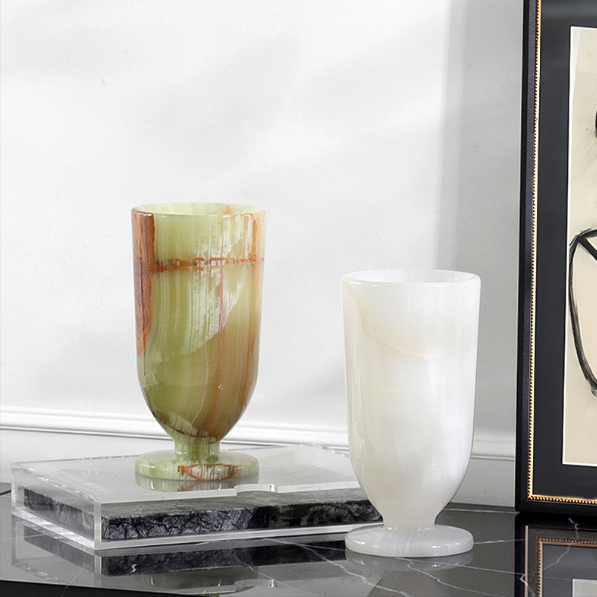Luxury natural marble pedestal vases in green and white stone displayed on clear acrylic riser