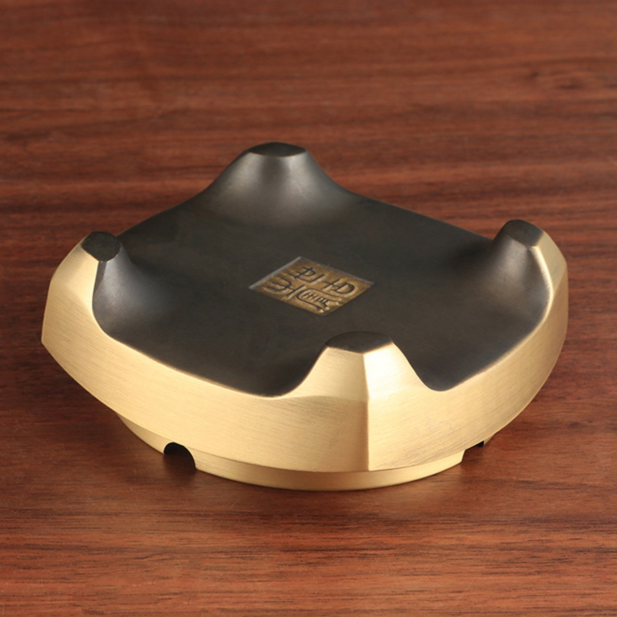 Bottom view of brass incense burner with raised feet and stable base