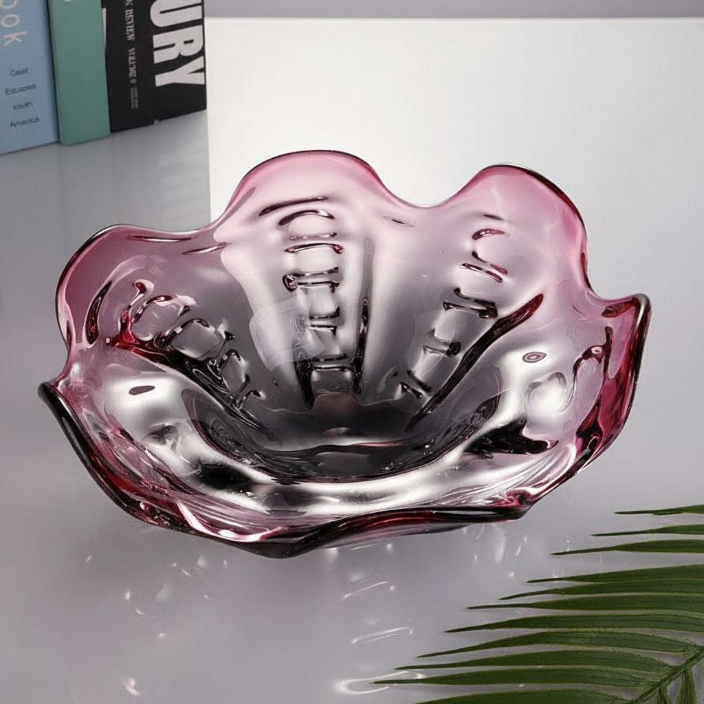 Sculptural plum art glass bowl showing its flowing ruffled interior