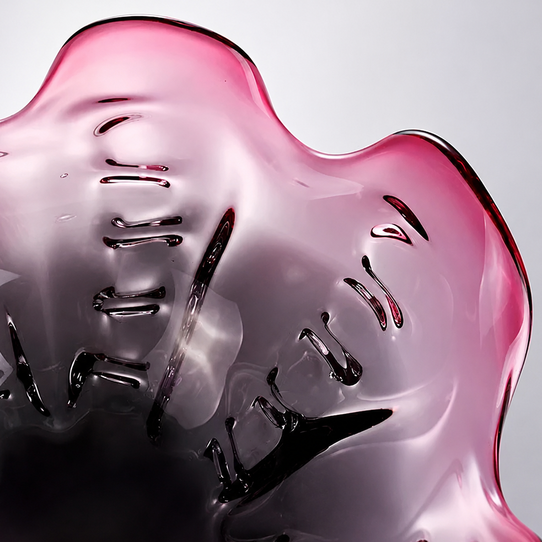 Close up of glossy plum art glass bowl and sculpted interior details