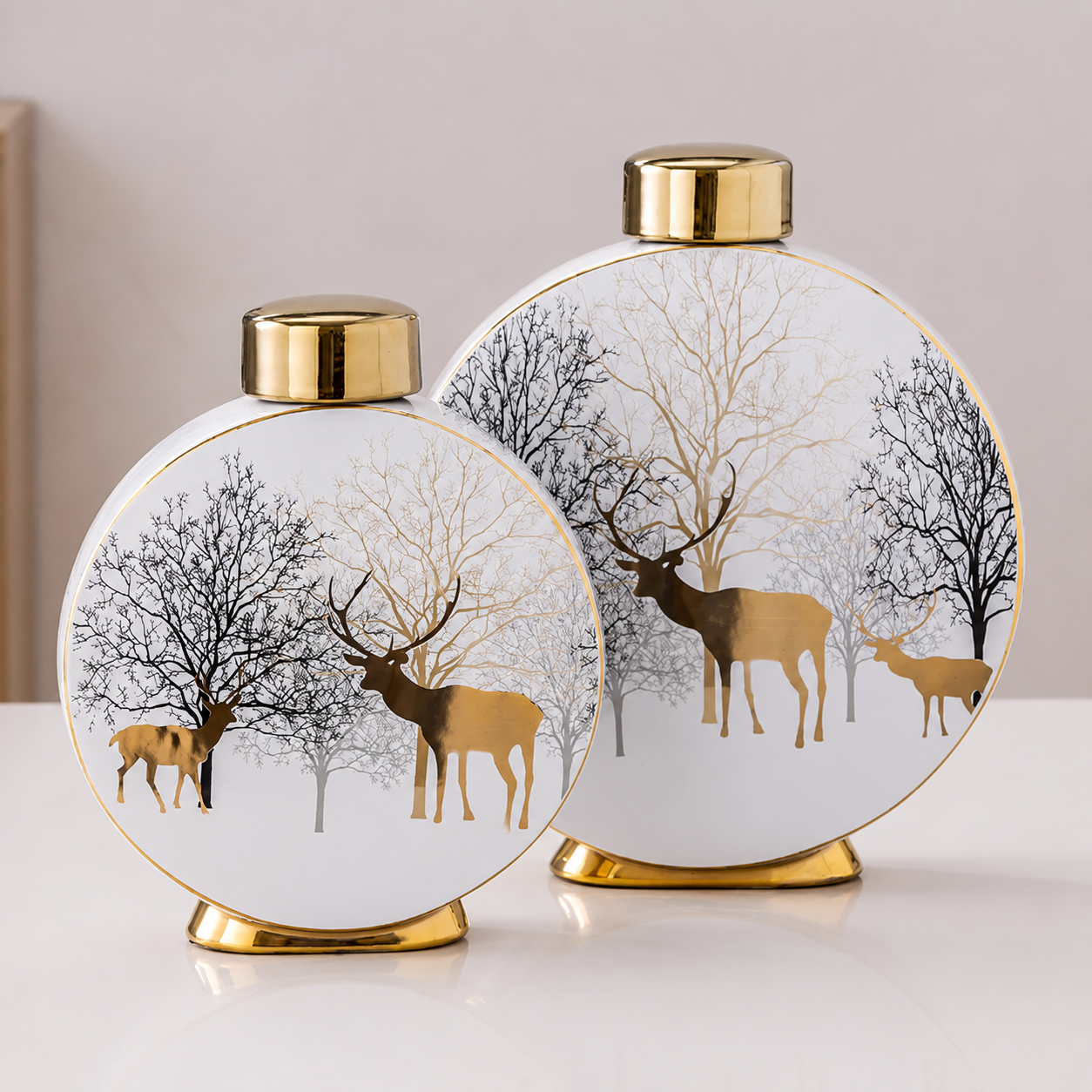 Medium and large Winter Deer ceramic vases with gold accents on tabletop