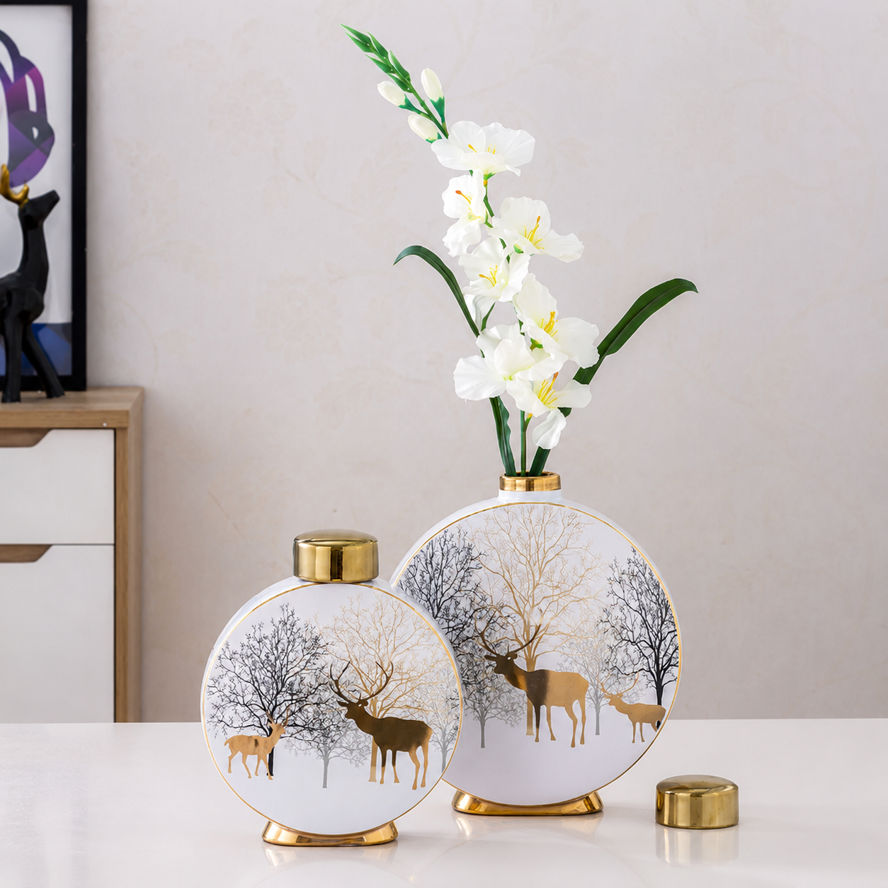 Winter Deer round ceramic vases styled with white flowers on modern tabletop