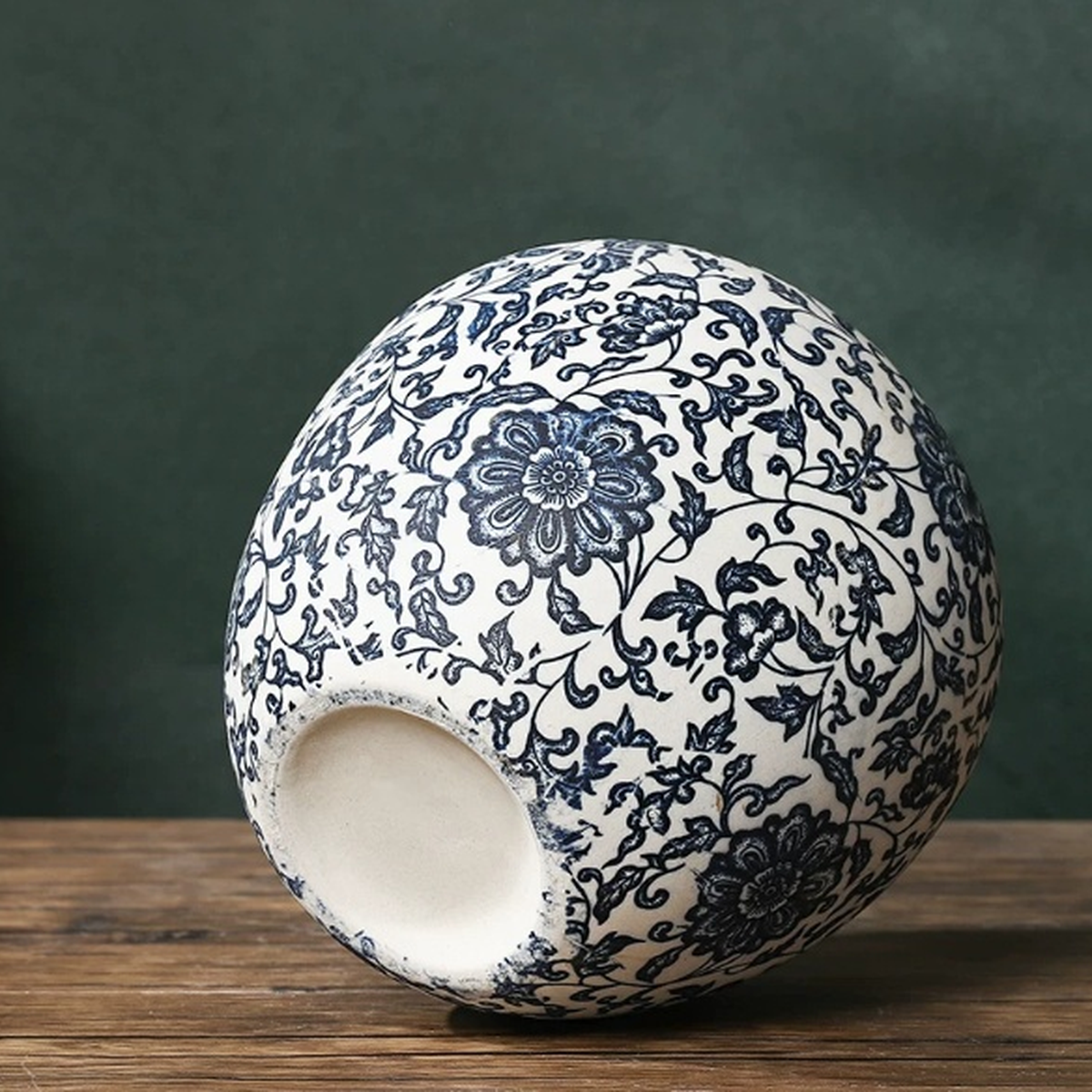 Blue and white ceramic vase shown tilted to display base detail