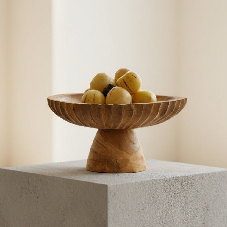 Wooden pedestal centerpiece bowl displayed on a white plinth