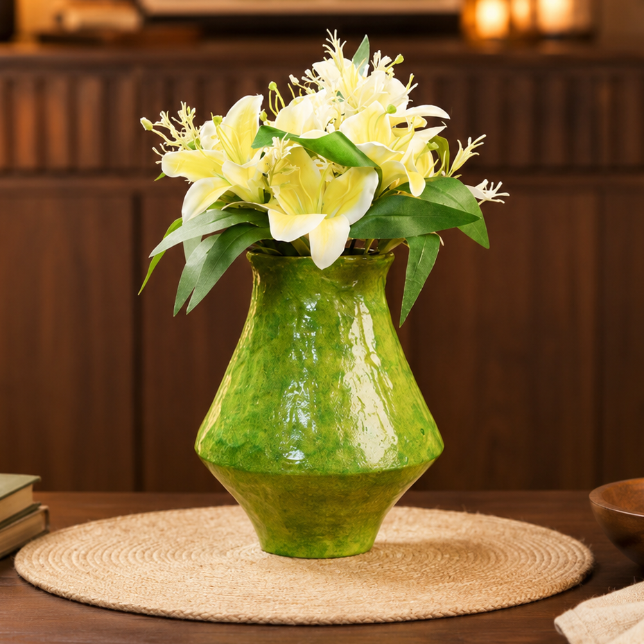 Green rustic ceramic flower vase with white lilies on a wooden table