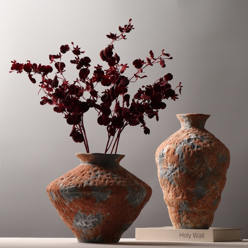 Short and tall rustic orange gray textured ceramic vases styled with burgundy branches