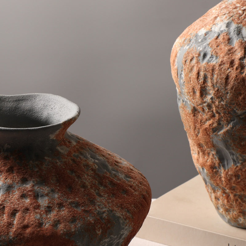 Close up of the weathered orange and gray texture on the ceramic vases