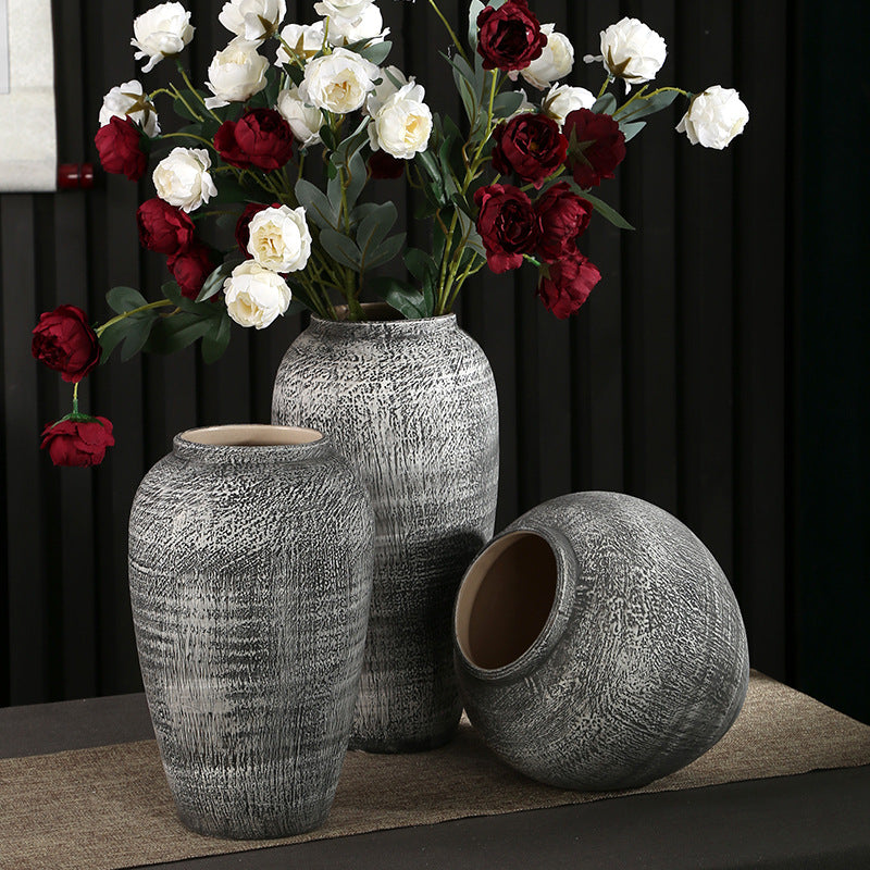 Textured gray ceramic vases shown upright and on their side to display the openings