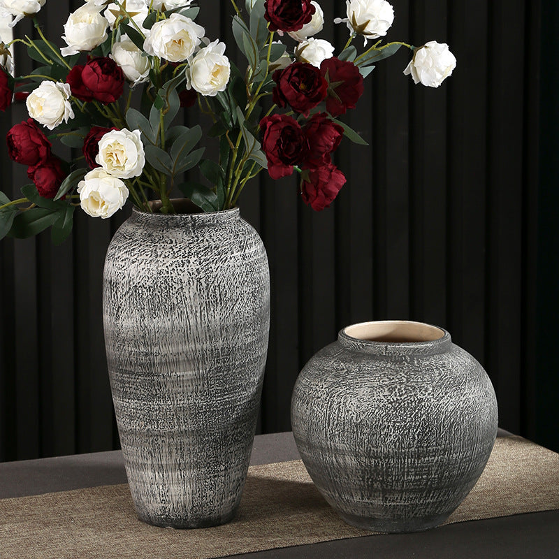 Tall and round textured gray ceramic decorative vases displayed together