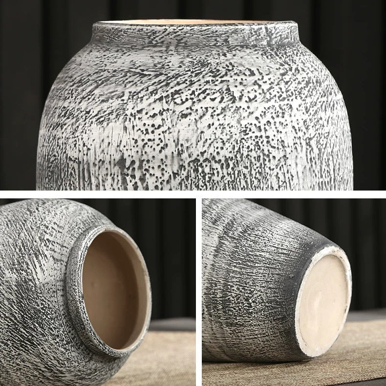 Close up views of the textured finish opening and base of the gray ceramic vase