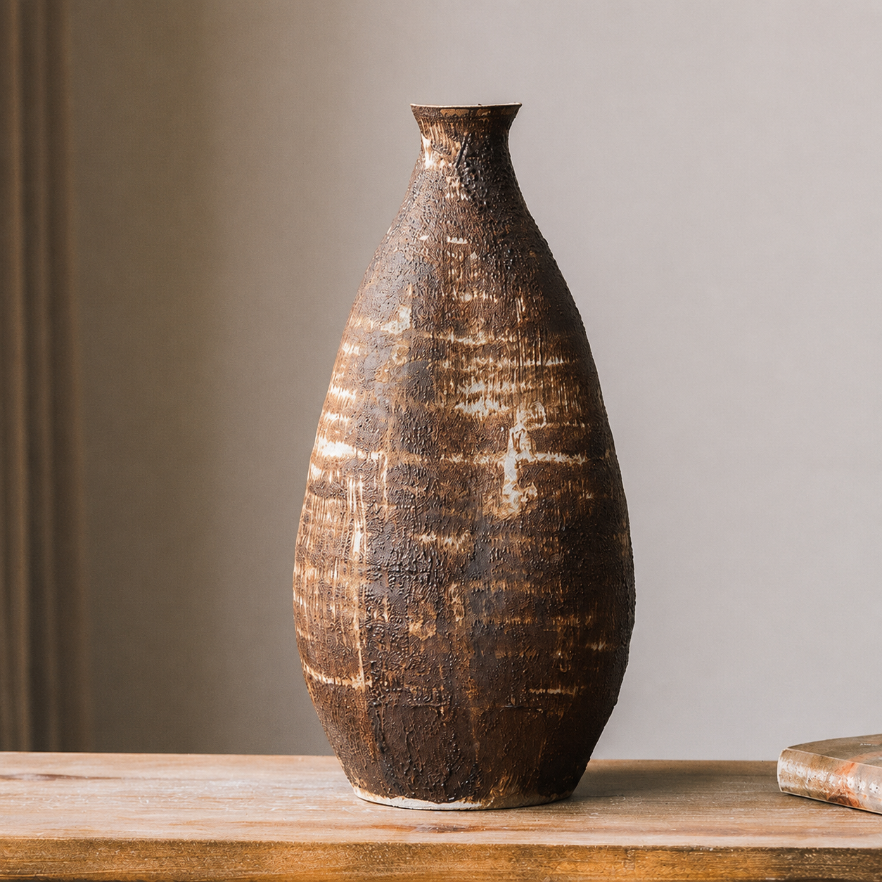 Tall rustic brown textured ceramic decorative vase on a wooden shelf