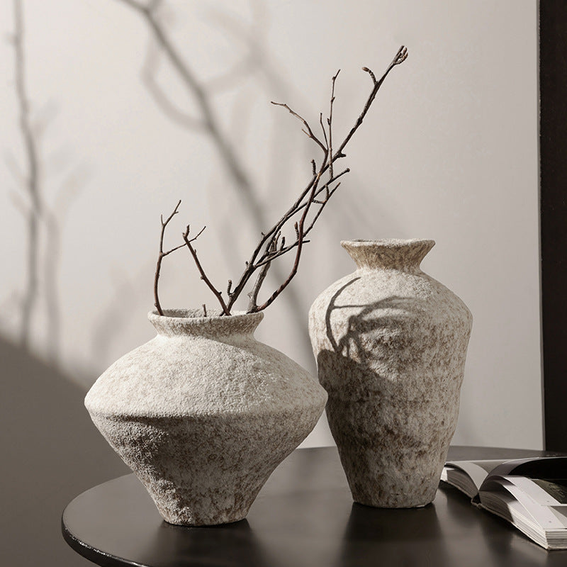 Pair of textured ceramic Wabi Sabi vases with dried branches in a calm neutral interior