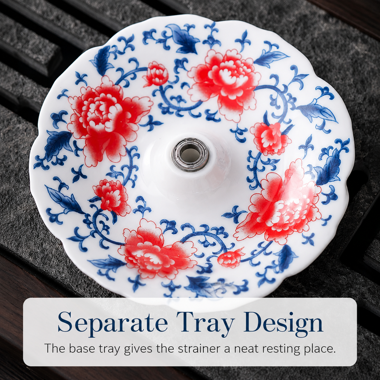Separate ceramic drip tray with red and blue floral design for resting the tea strainer