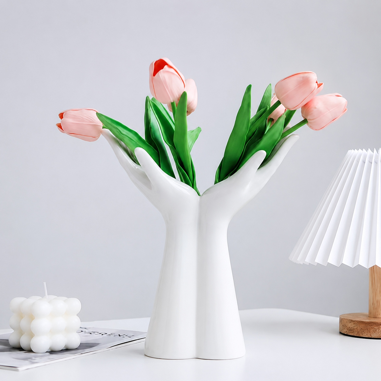 White ceramic open palm vase styled with pink tulips for elegant floral decor