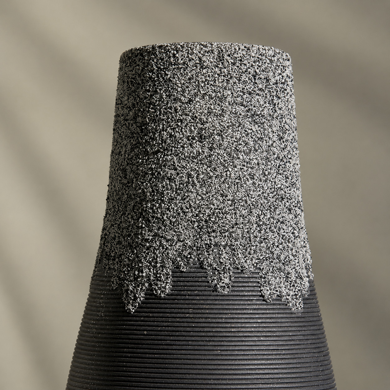 Close up of mineral inspired textured finish on black ceramic vase