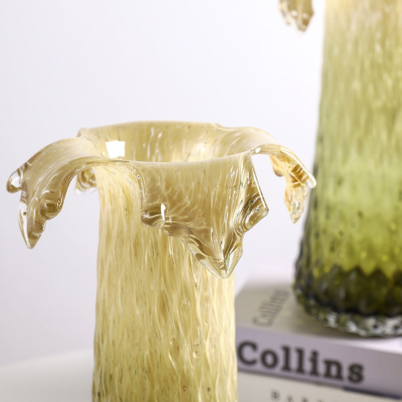 Close up of sculptural glass vase showing flowing ruffled rim and gradient texture
