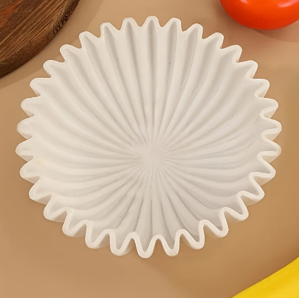 Top view of white sculptural resin bowl showing radiating fluted texture