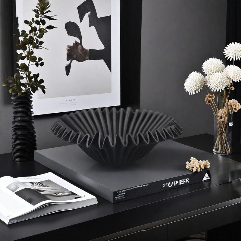 Black sculptural resin centerpiece bowl styled in modern interior